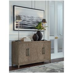 a living room scene with focus on the sideboard and lamp in the foreground