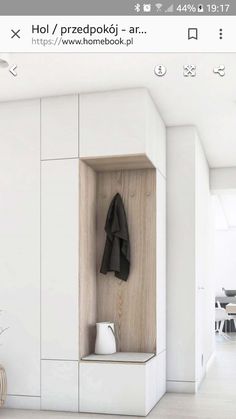 a white room with a coat hanging on the wall