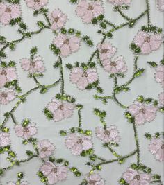 pink flowers and green leaves are on a light blue background, with sequins