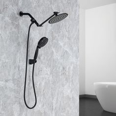 a shower head with thermostaer and handset in front of a marble wall