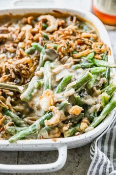 a casserole dish filled with green beans and rice