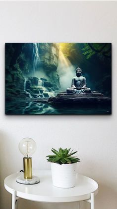 a buddha statue sitting on top of a white table next to a potted plant