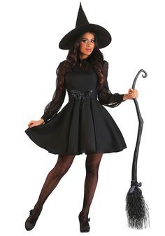 a woman in a witch costume holding a broom