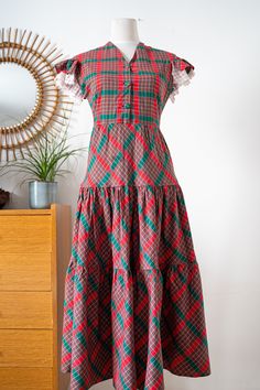 "Vintage 1930's 30s Style Handmade Dress * red and Green Plaid Cotton * Size M DESCRIPTION : - Red and Plaid cotton fabric - Lace details on the shoulders - 3 Matching fabric-covered buttons - Side metal zipper The garment is not easy to date due to its handmade nature but please note the metal zipper on the side and other details that seem to indicate it is a true vintage 1930s piece. INFOS : // label: - none // color: Red and Green // fabric: not tagged - feels like cotton // condition: Used condition - No Holes, stains or odor. A few period repairs (see pictures) and a bit of bleeding on the lace. // size: Feels like Medium but please refer to measurements: - shoulder to shoulder: 17'' - 43cm - armpit to armpit: 17.5'' - 45cm - waist: 16'' - 41cm - total lenght : 47''- 119cm SALES POLIC Red Cotton Vintage Dress, 30s Style, 30s Fashion, Dog Bones, Handmade Dress, Fashion Aesthetics, Handmade Dresses, Green Plaid, Green Fabric