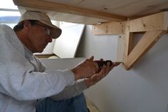 a man is working on some wooden beams