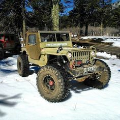 an old jeep is parked in the snow