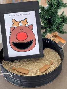 a christmas card is placed in a pan filled with sand