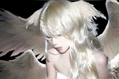 a woman with white hair and angel wings