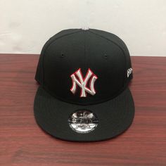 a new york yankees hat sitting on top of a wooden table