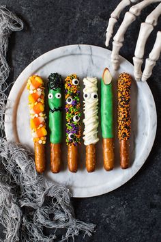 halloween treats are arranged on a white plate