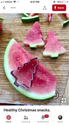 watermelon slices cut into christmas trees on a cutting board