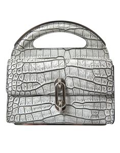 Featuring a chic leather top handle, this mini bag opens to a black inner lining. Craftsmanship is apparent in every detail, reflecting Balenciaga’s luxury and style. Made in Italy     Material: 100% Alligator skin Leather  Color: Silver  Country of origin: Italy  Logo details  Dimensions: 21cm x 20.5cm x 8.5cm Skins Mini, Italy Logo, Leather Mini Bag, Balenciaga Leather, Alligator Skin, Chic Leather, Mini Purse, Winter Accessories, Leather Mini