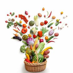 a basket filled with lots of different types of fruits and vegetables flying out of it