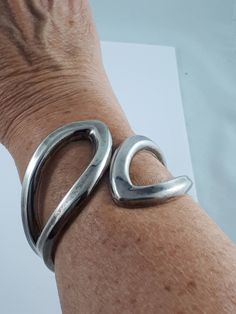 "This is a nice chunky hinged Sterling Silver cuff. SKU-330  Its simple design is easy to wear and live with every day.  Although the cuff is 8\" around the wrist, it can be worn up the arm comfortably if you have a small wrist. The hinge mechanism makes it easy to open the cuff and slip it on.  This cuff is solid, and has a nice weight to it. D E T A I L S: Measures approx. 8.0 inches long x 2.5\" wide. Weighs approx. 57.9 grams Hallmark: Stamped \"925 \"inside the cuff Condition: Very good vin Modern Metal Wide Band Bracelets, Modern Wide Band Metal Bracelet, Adjustable Contemporary Cuff Bracelet, Silver Arm Cuff, Arm Cuff, Dainty Bracelets, Sterling Silver Cuff, Professional Cleaning, Silver Cuff