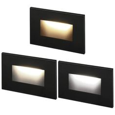 three square lights are mounted on the side of a wall, each with an illuminated surface