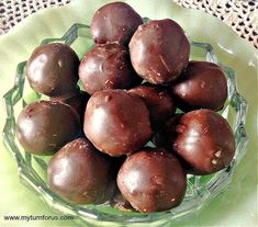 a glass bowl filled with chocolate candies on top of a table