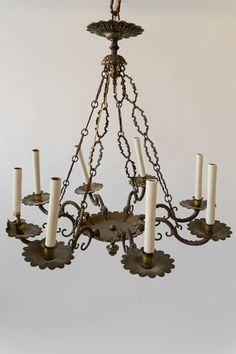 a chandelier with six candles hanging from it