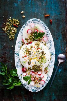 a white plate topped with food and veggies on top of a blue table