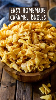 a wooden bowl filled with macaroni and cheese on top of a wooden table