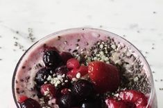 a smoothie topped with berries and chia seeds