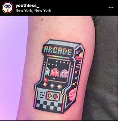 an old school arcade game tattoo on the arm