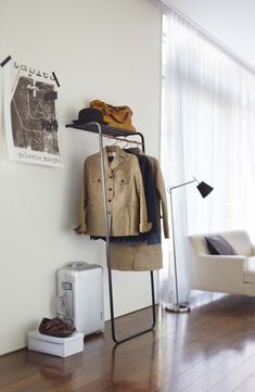 a clothes rack in the corner of a room