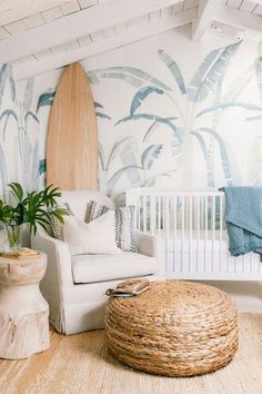 a living room with a surfboard on the wall next to a chair and ottoman