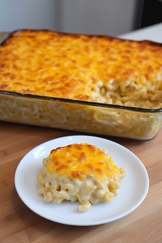 a casserole dish on a white plate next to a baking pan filled with macaroni and cheese