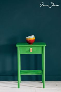 a green table with a bowl on top