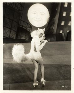 an old photo of a woman dressed as a cat