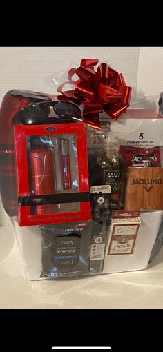 a red coffee maker sitting on top of a counter next to a box filled with other items