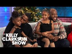 the kelly clark show with two children and an adult sitting on a couch in front of a christmas tree