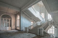 an abandoned building with stairs and windows