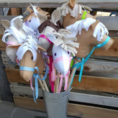 some paper mache horses are in a bucket