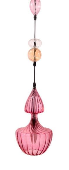 three pink glass lamps hanging from a ceiling