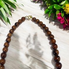 This necklace boasts a clasp closure, showcasing the exquisite natural appearance of Hawaiian Koa Wood, embodied by its 8mm beads. With sizes available in 16, 18, and 20 inches, this popular piece is renowned for its authentic and timeless allure. Material: Koa Wood Bead Size: 8mm Clasp Closing Size: 16 inch | 18 inch | 20 inch Classic Beaded Necklaces With Round Beads, Classic Beaded Necklaces With Round Beads For Everyday, Classic Single Strand Beaded Necklaces, Classic Single Strand Beaded Necklace For Everyday, Classic Necklace With 8mm Beads For Gift, Classic 8mm Beads Necklace For Gifts, Classic 8mm Bead Necklaces As Gifts, Classic 8mm Beaded Necklaces As Gift, Classic 8mm Bead Necklaces Perfect For Gifts