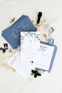 the wedding stationery is laid out on top of each other