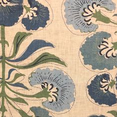 a blue and green flower pattern on fabric