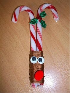 two candy canes decorated to look like rudolph the reindeer