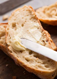 a piece of bread with butter on it and a knife sticking out of the top