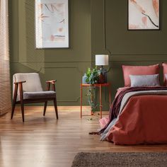 a bed room with a neatly made bed next to two chairs and a painting on the wall