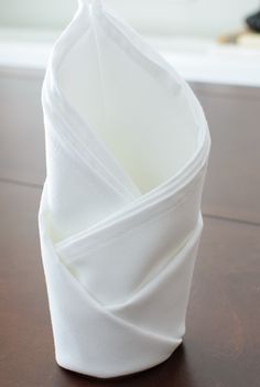 folded napkins sitting on top of a wooden table