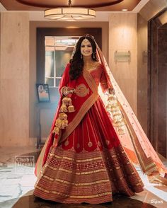 a woman in a red and gold bridal gown