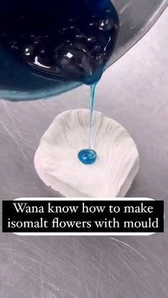 a blue liquid pouring into a white bowl on top of a metal surface with the words, want know how to make isomani flowers with mould