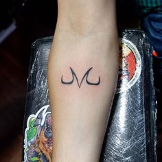 a person with a tattoo on their arm that has the letter v in cursive writing