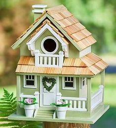 a bird house on top of a tree stump