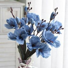 a vase with blue flowers in it on a table