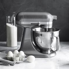 an image of a mixer and eggs on the counter