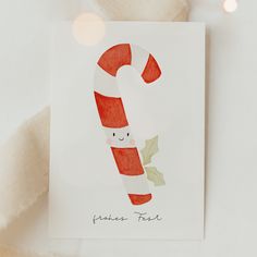 a christmas card with a candy cane on it