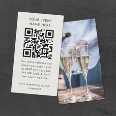 two glasses of champagne sitting on top of a table next to a qr code